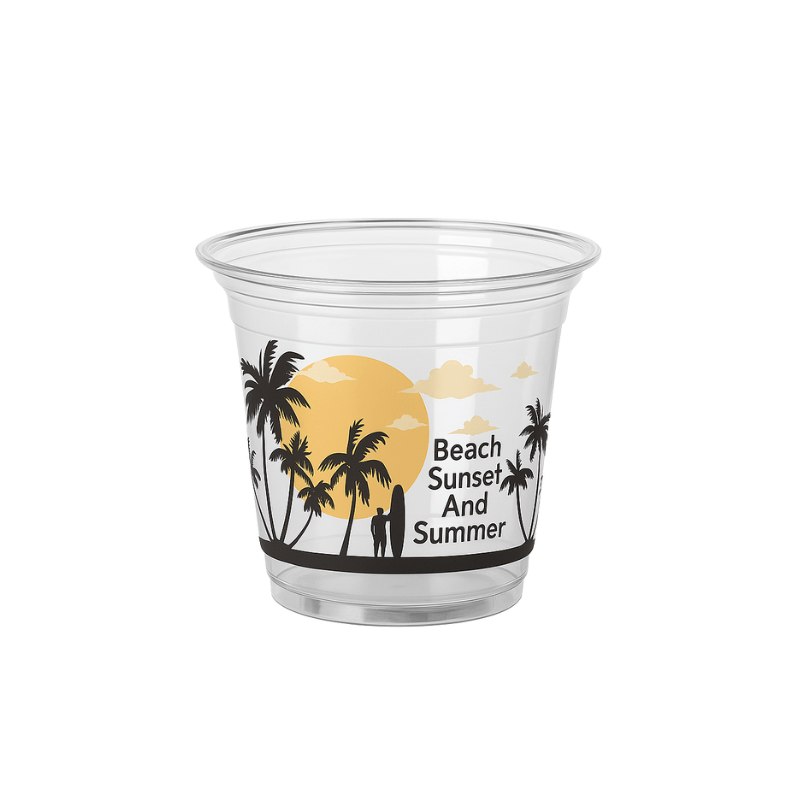 Clear plastic cup with a “Beach Sunset And Summer” design showing palm tree silhouettes, a large sunset, and a couple standing on the beach on a white background.