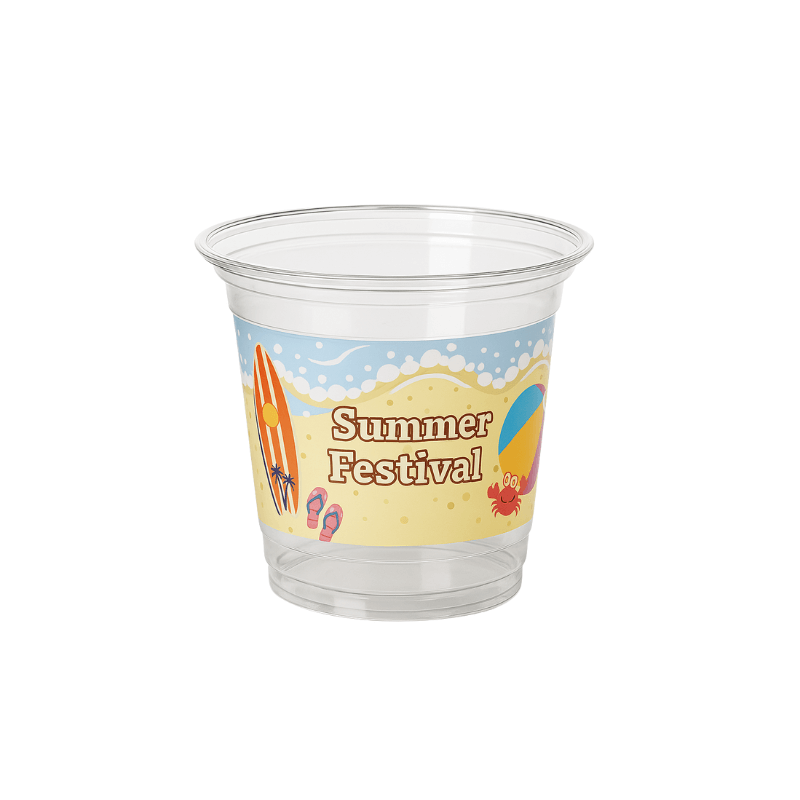 Clear plastic cup with a beach-themed “Summer Festival” wrap featuring waves/foam, surfboards, flip-flops, and a crab on a white background.