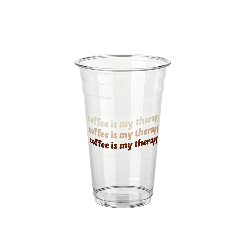 Clear plastic cup with repeated text reading “coffee is my therapy” in three shades of brown on a white background.