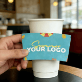 Teal ‘Summer’ cup sleeve with a customizable logo held against a white paper cup in a cafe.