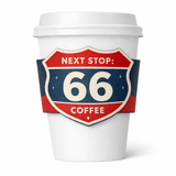 White paper cup with a retro highway-shield sleeve in red, white, and blue reading “NEXT STOP: 66 COFFEE.